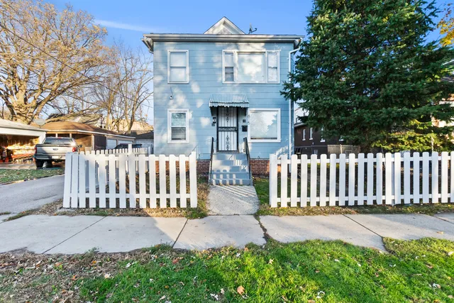 a view of a house with wooden fence