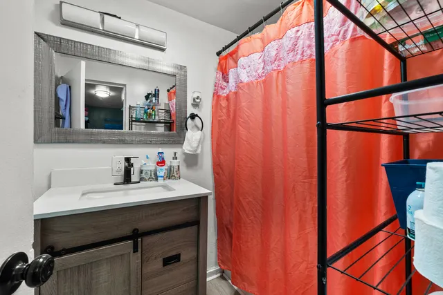 a bathroom with a sink vanity and a mirror