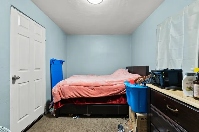 a bedroom with a bed and a desk