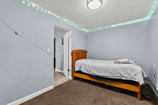 a bedroom with a bed and window