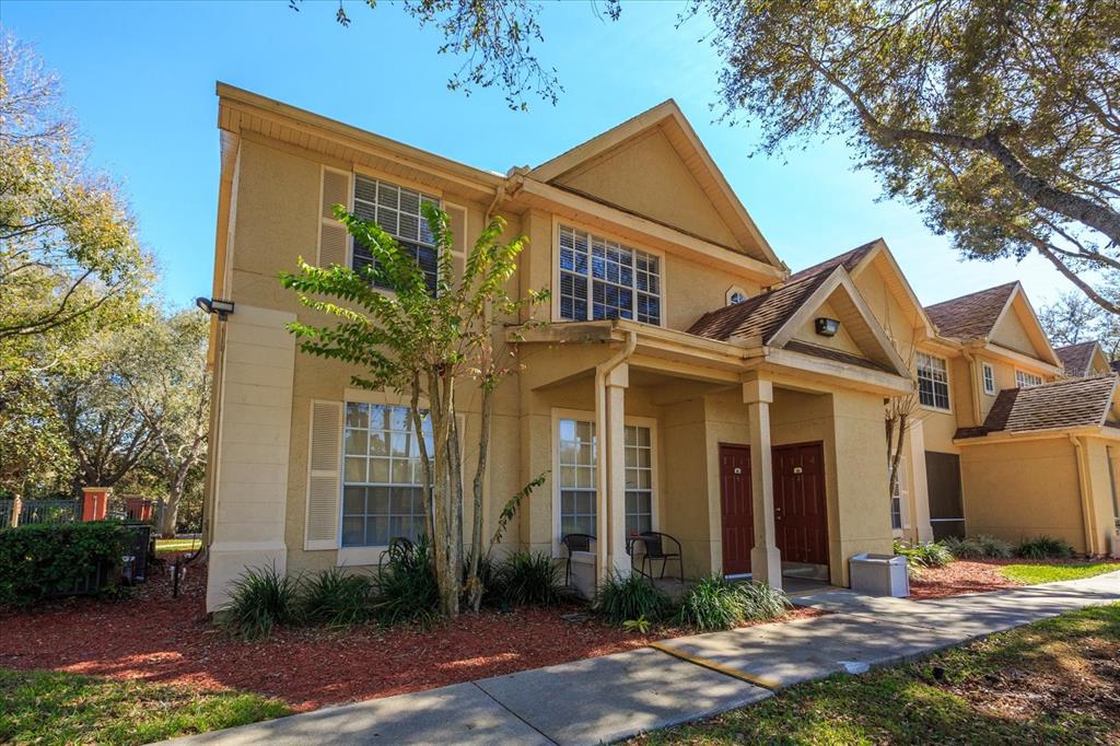 819 Grand Regency Pointe, Unit 203 Altamonte Springs, FL 32714 - Photo 1 of 21 a front view of a house with garden