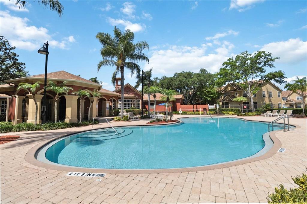819 Grand Regency Pointe, Unit 203 Altamonte Springs, FL 32714 - Photo 20 of 21 a view of a swimming pool with a bench in patio