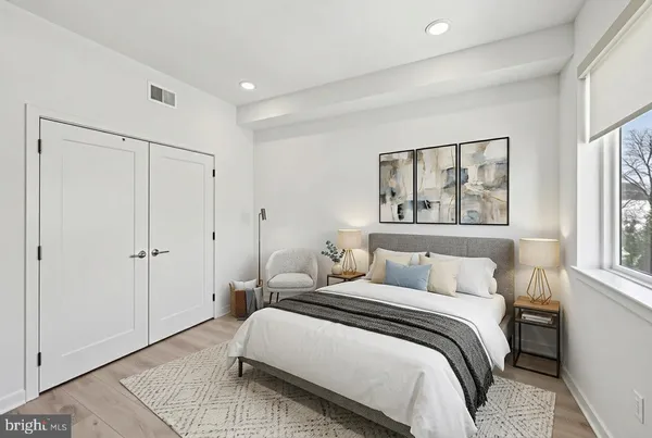 a bedroom with a bed and a painting on the wall