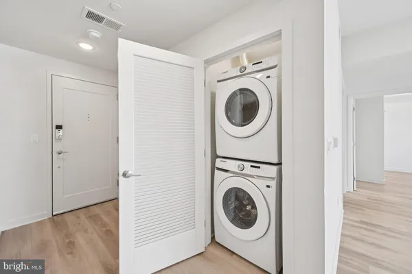 a view of a hallway with washer and dryer