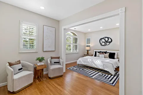 a living room with furniture dining table and a wooden floor
