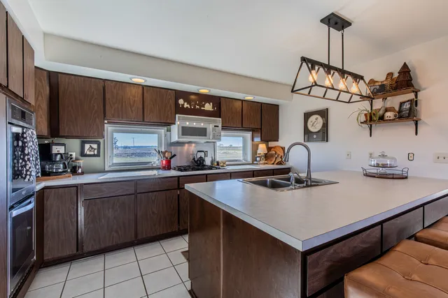 a kitchen with a sink a stove and cabinets