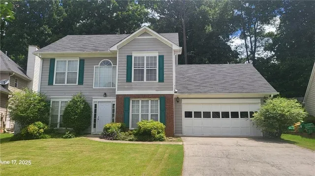 a front view of a house with a yard