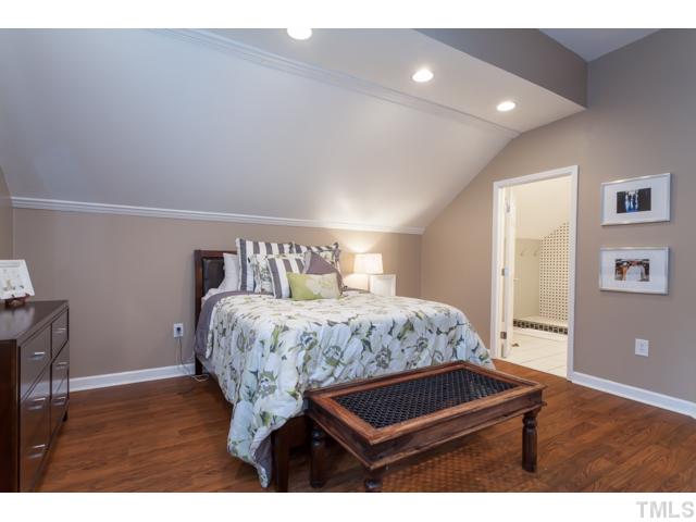 4521 Hershey Court Raleigh, NC 27613 - Photo 11 of 24 a bedroom with a bed window and wooden floor