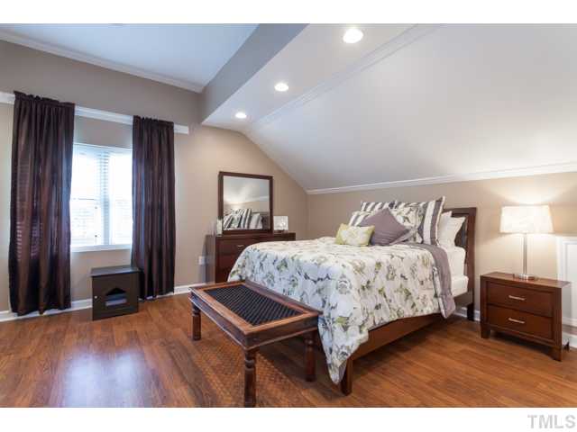 4521 Hershey Court Raleigh, NC 27613 - Photo 10 of 24 a bedroom with a bed table and a dresser