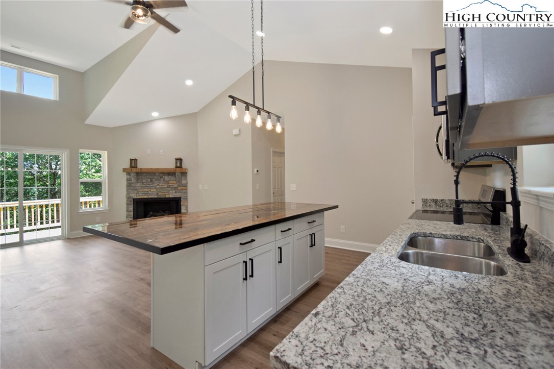 598 Running Deer Trail Boone, NC 28607 - Photo 18 of 49 a kitchen with granite countertop a sink a counter top space appliances and cabinets
