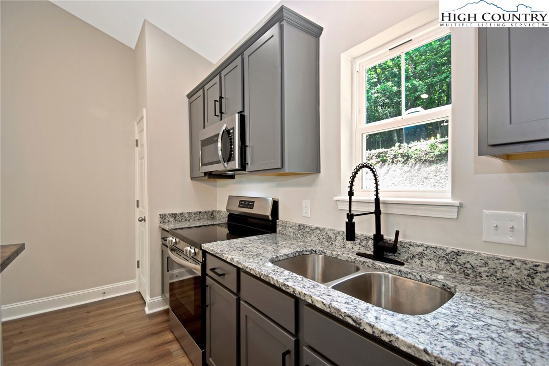 598 Running Deer Trail Boone, NC 28607 - Photo 20 of 49 a kitchen with sink cabinets and window