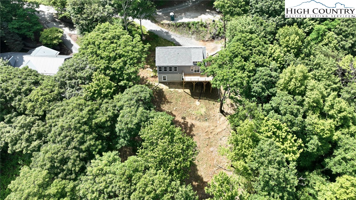 598 Running Deer Trail Boone, NC 28607 - Photo 45 of 49 an aerial view of a house with a yard and large trees
