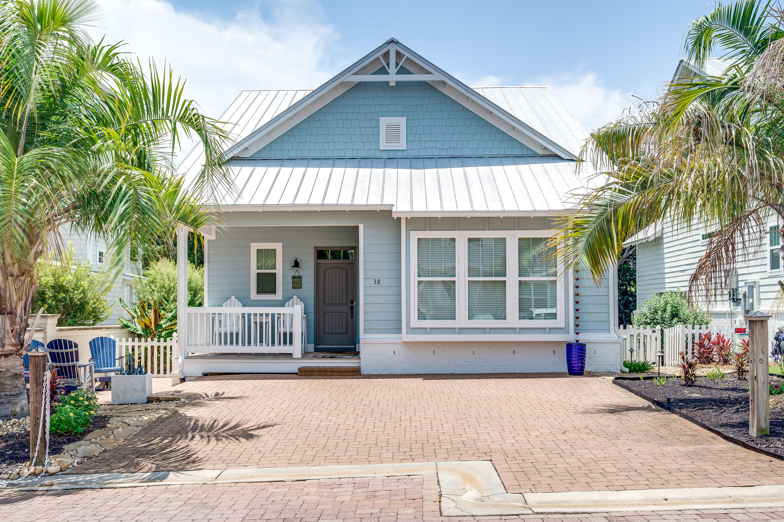 38 Inlet Cove Inlet Beach, FL 32461 - Photo 2 of 51 a front view of a house with a yard and garage