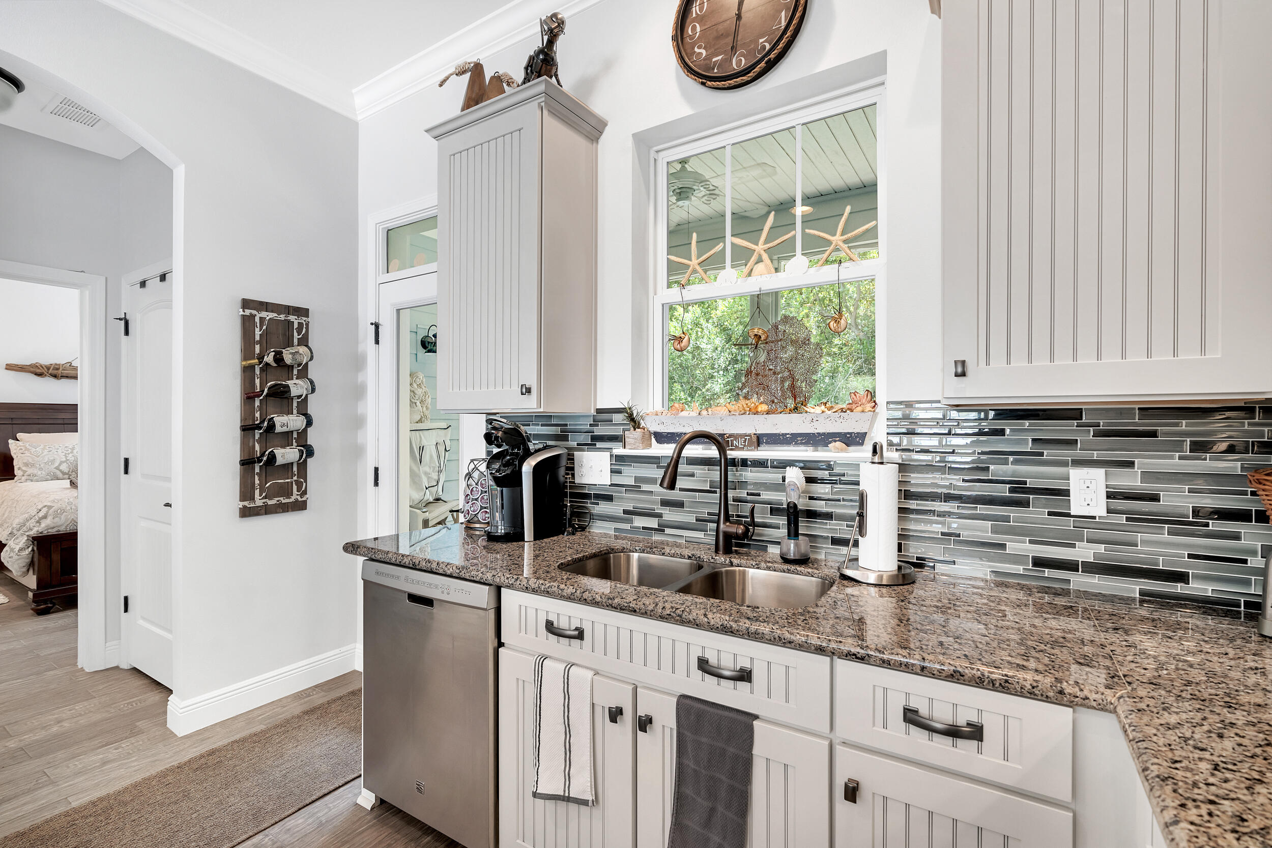 38 Inlet Cove Inlet Beach, FL 32461 - Photo 30 of 51 a kitchen with granite countertop a sink a window and a white wooden cabinets