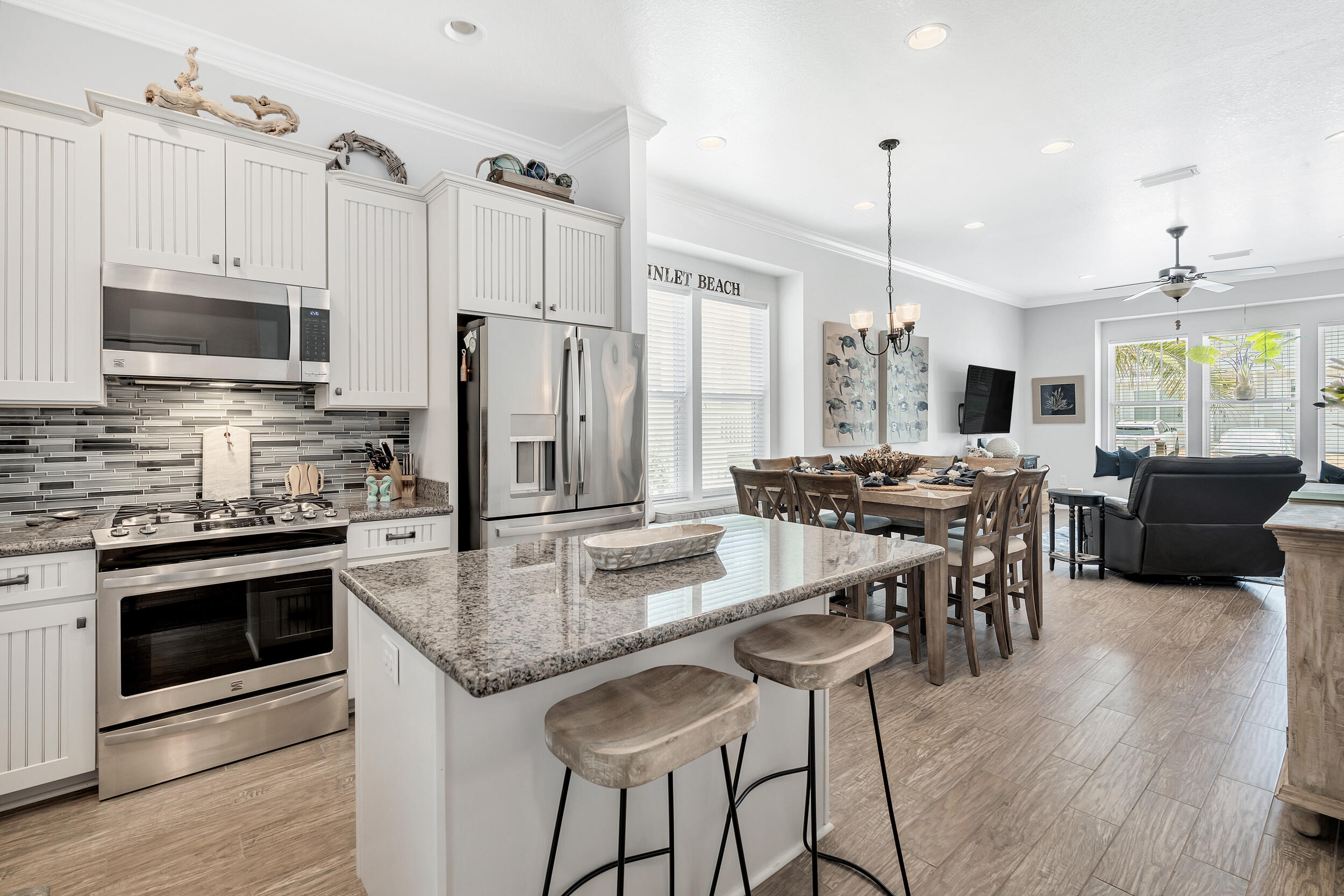 38 Inlet Cove Inlet Beach, FL 32461 - Photo 31 of 51 a kitchen with stainless steel appliances granite countertop a stove top oven a refrigerator a sink and a dining table with wooden floor