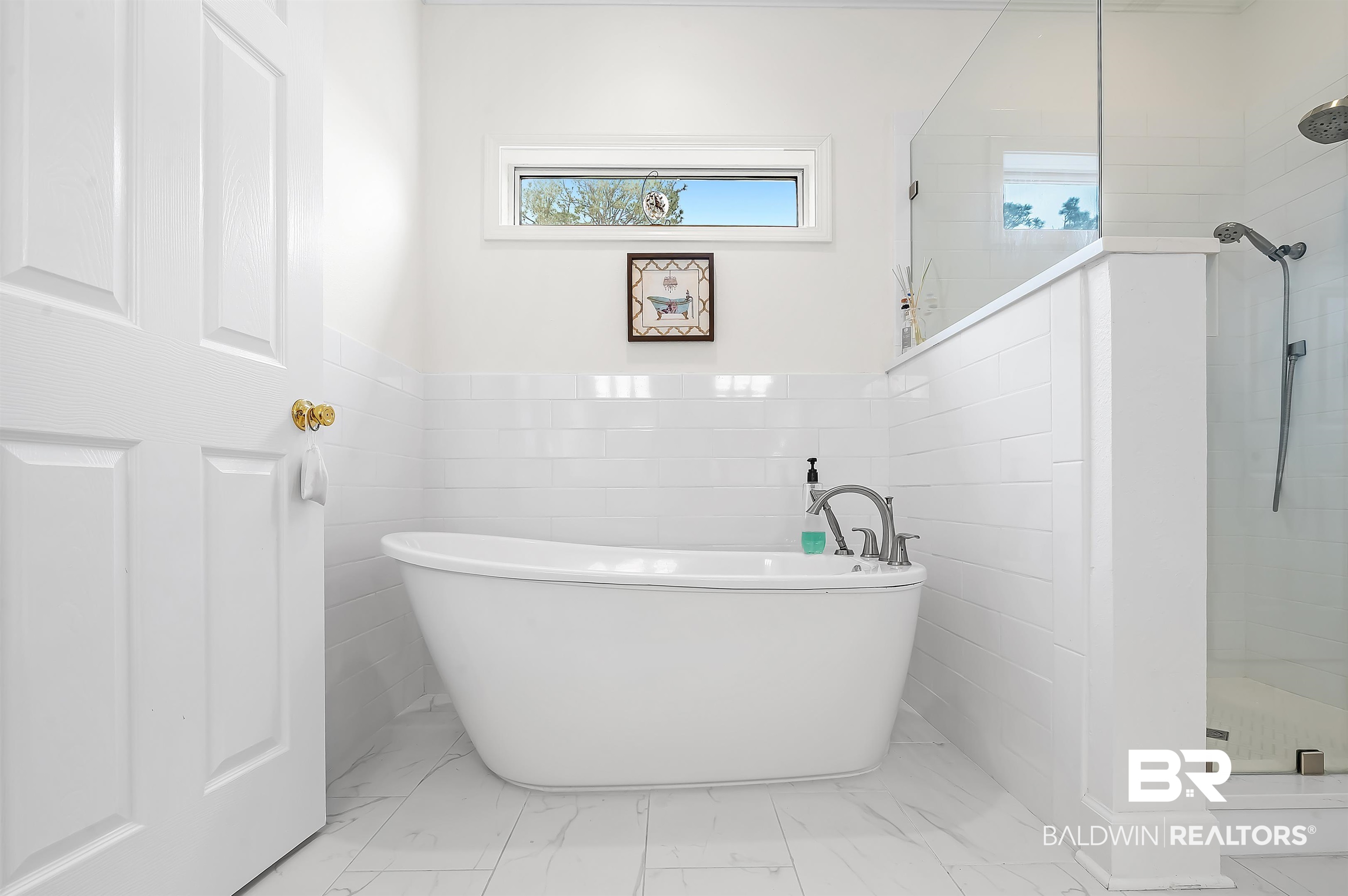 8915 Bay Point Drive Elberta, AL 36530 - Photo 55 of 74 Bathroom featuring a freestanding tub, marble finish floor, a tile shower, and tile walls
