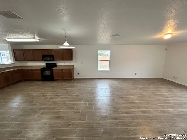 a room with a chair and cabinets