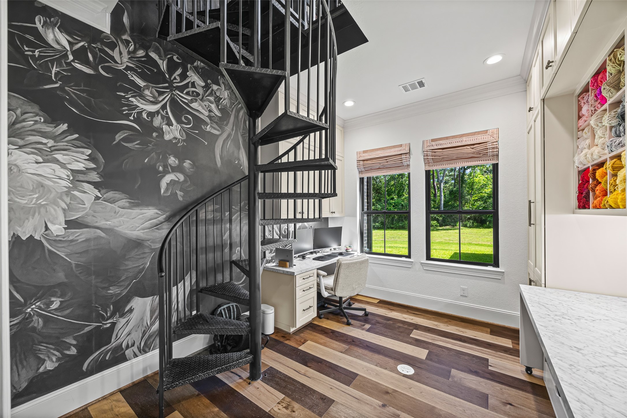 19314 Chateau Ridge Court Tomball, TX 77377 - Photo 22 of 50 Downstairs office #1 and creative studio featuring a spacious layout ideal for drafting, crafting, or hands-on work, complete with a striking spiral staircase that connects directly to the upstairs library.