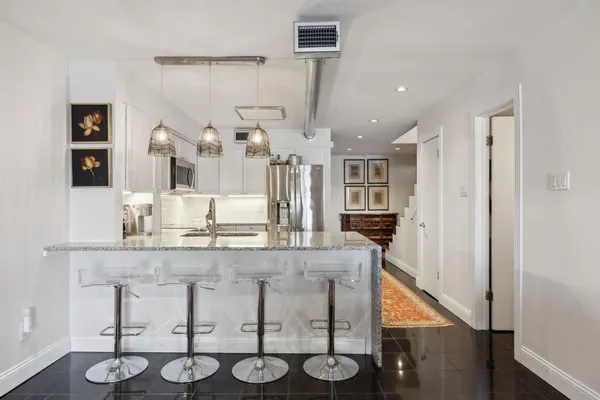 a kitchen with stainless steel appliances granite countertop a sink and cabinets