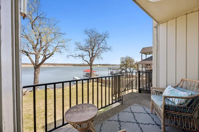 a bathroom with a granite countertop sink toilet mirror and shower