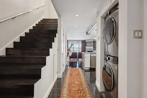 a kitchen with stainless steel appliances granite countertop a sink refrigerator and microwave