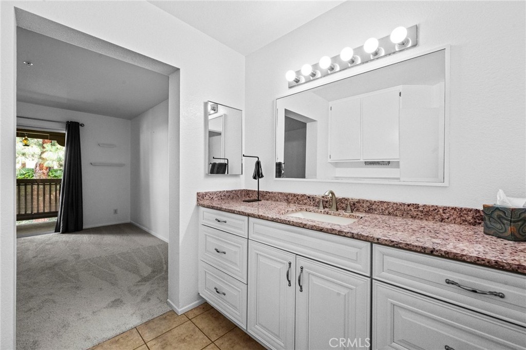 215 South Cross Creek Road, Unit L Orange, CA 92869 - Photo 27 of 50 a bathroom with a sink and a mirror