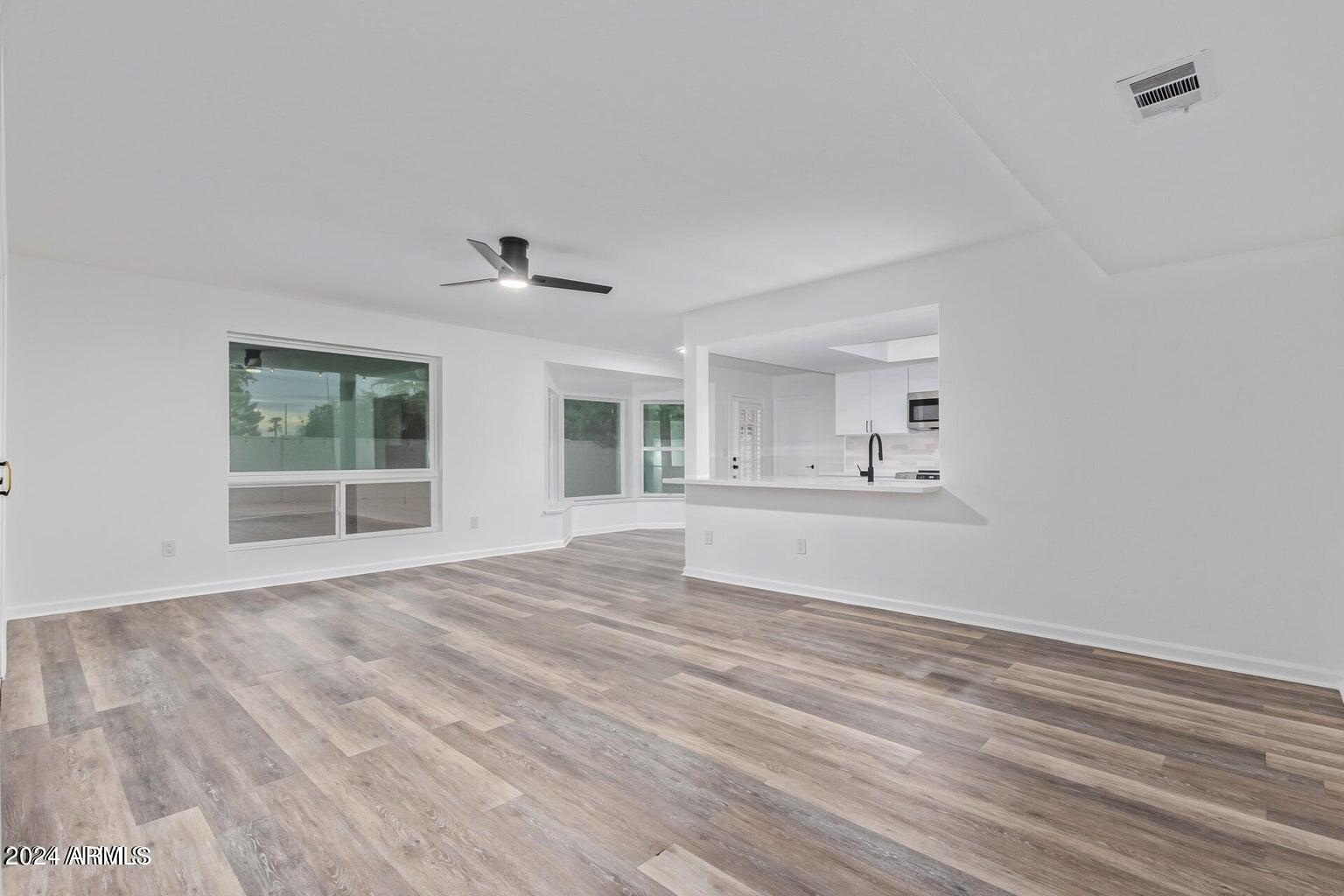 1893 East Bendix Drive Tempe, AZ 85283 - Photo 13 of 45 a view of an empty room with kitchen and a window