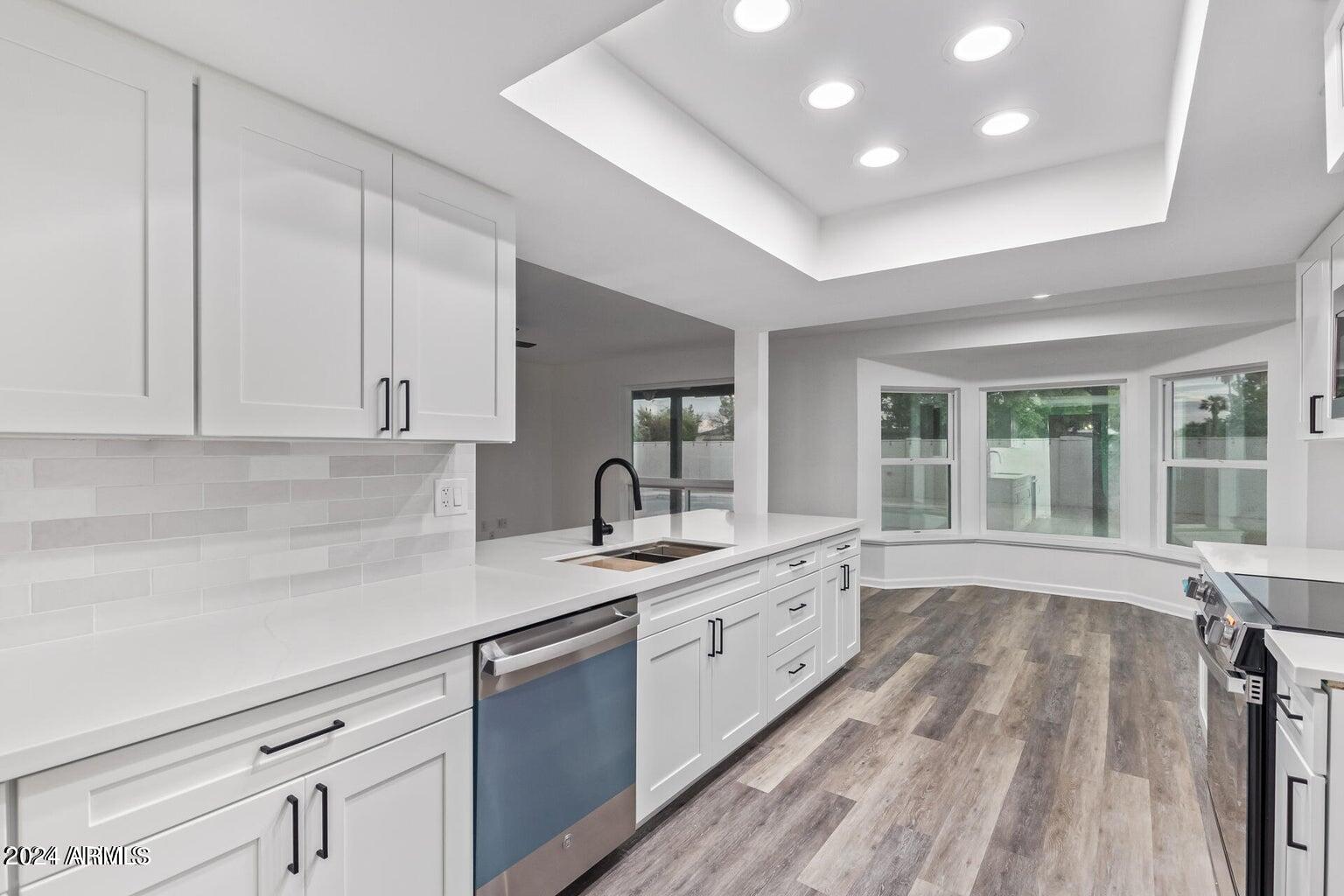 1893 East Bendix Drive Tempe, AZ 85283 - Photo 7 of 45 a view of a kitchen with sink and dishwasher with wooden floor
