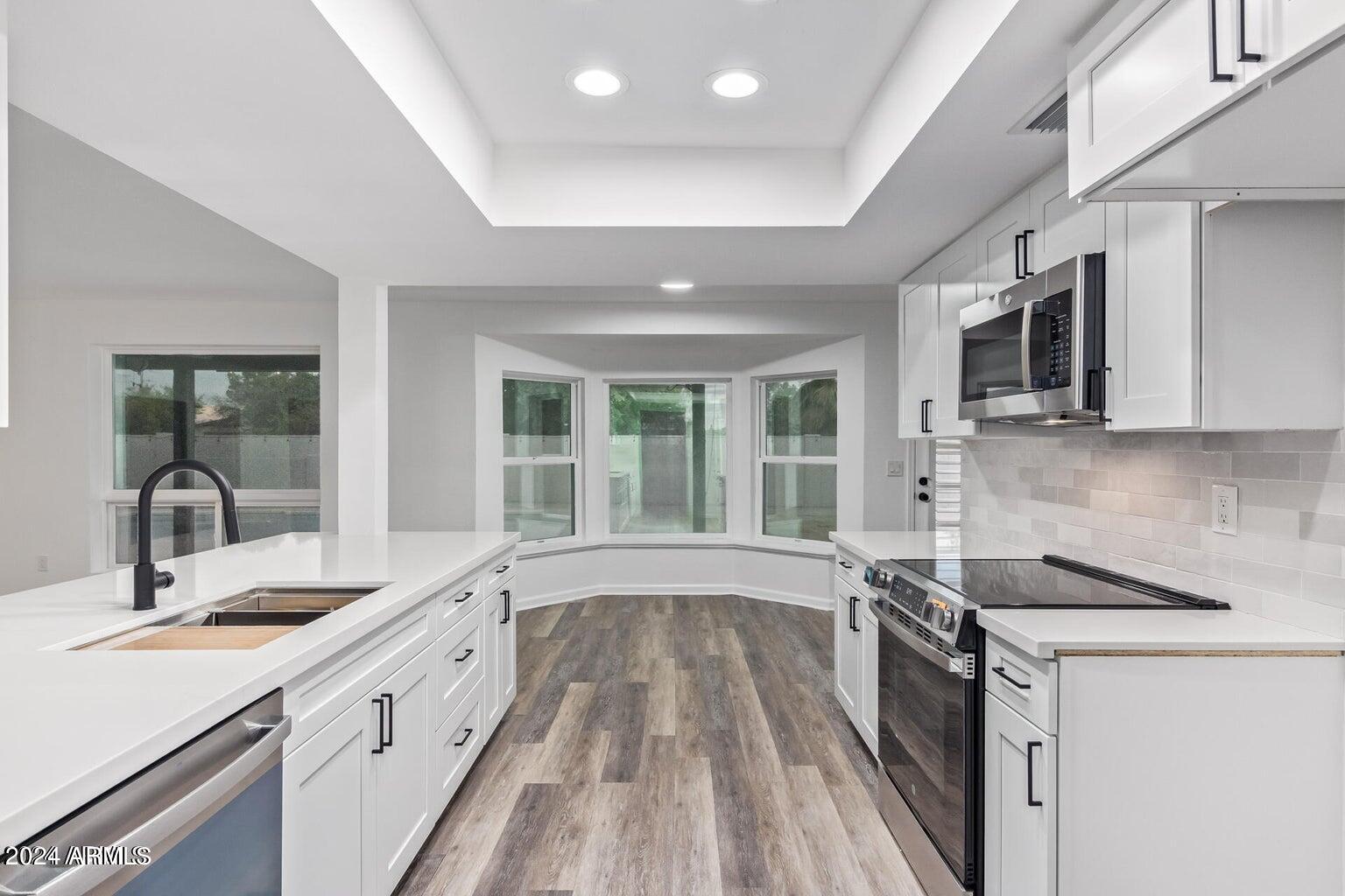 1893 East Bendix Drive Tempe, AZ 85283 - Photo 8 of 45 a view of a kitchen with a sink and wooden floor