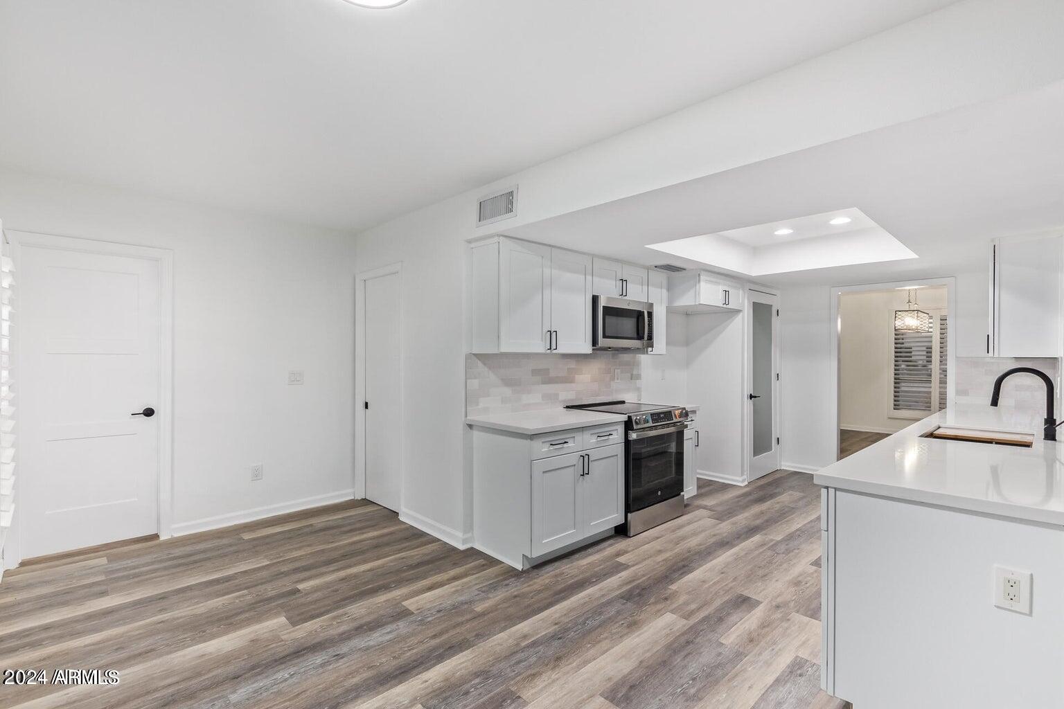 1893 East Bendix Drive Tempe, AZ 85283 - Photo 9 of 45 a kitchen with stainless steel appliances granite countertop a sink and stove top oven