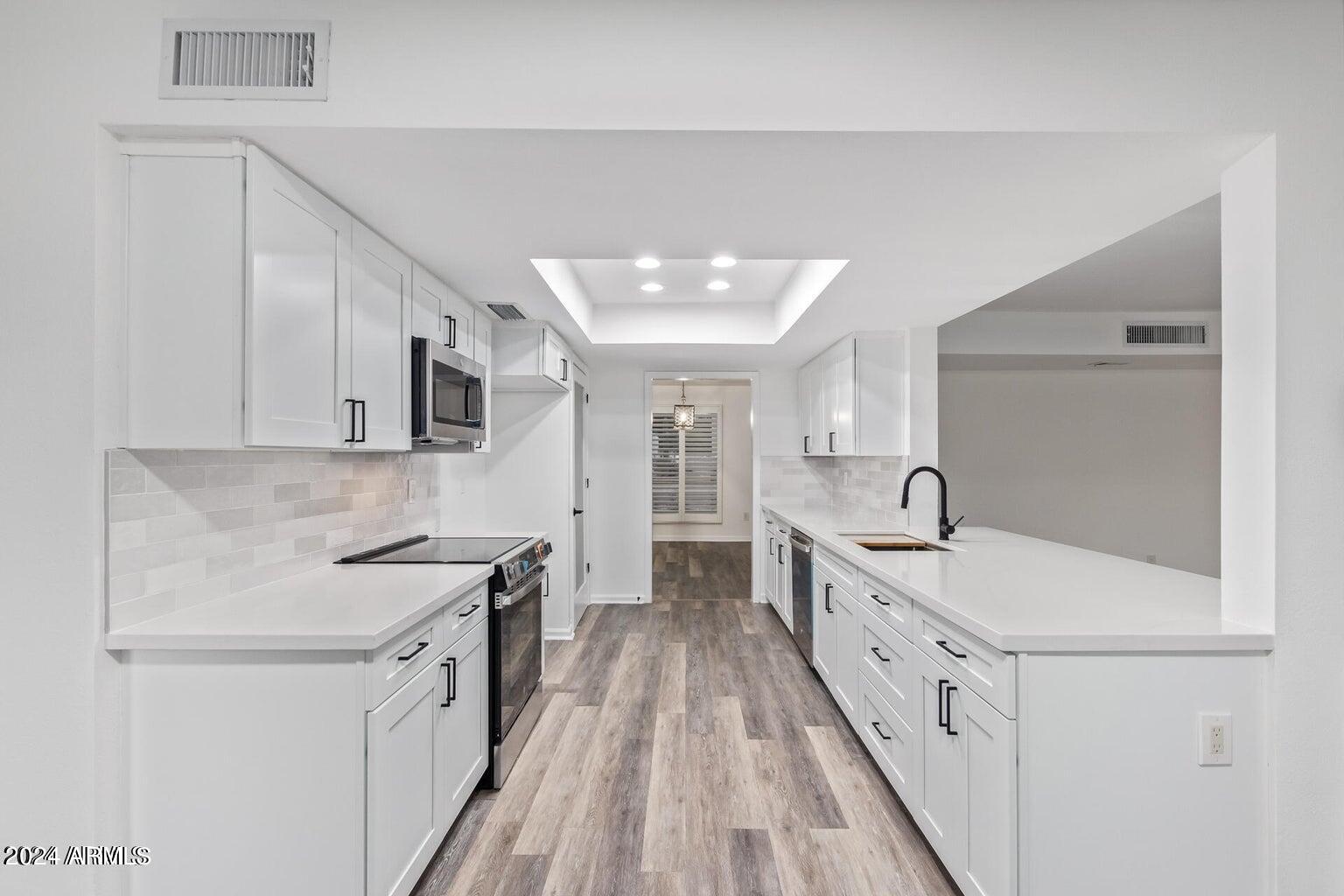 1893 East Bendix Drive Tempe, AZ 85283 - Photo 10 of 45 a kitchen with sink stove and cabinets