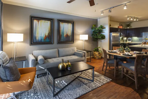 a living room with furniture and wooden floor
