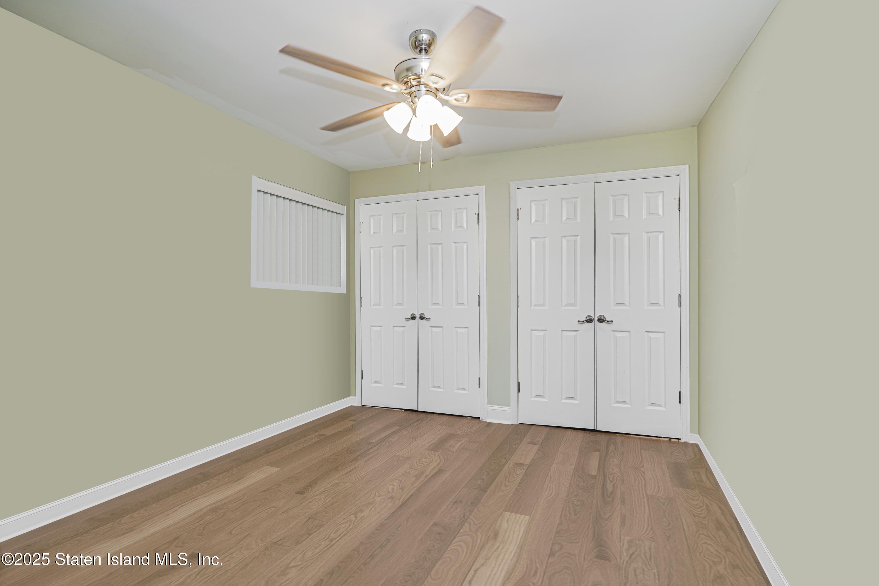 170 Devon Loop, Unit 3 Staten Island, NY 10314 - Photo 16 of 22 wooden floor in an empty room