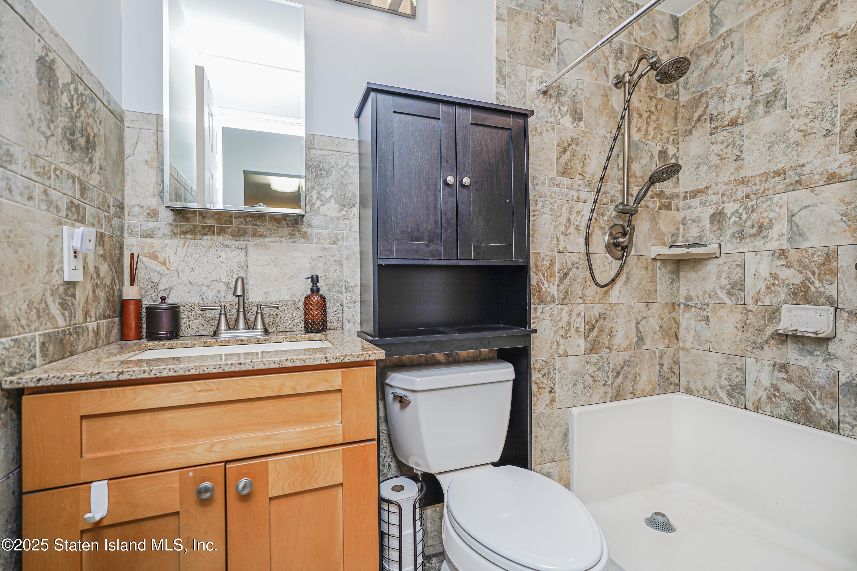 170 Devon Loop, Unit 3 Staten Island, NY 10314 - Photo 18 of 22 a bathroom with a sink a toilet and bathtub