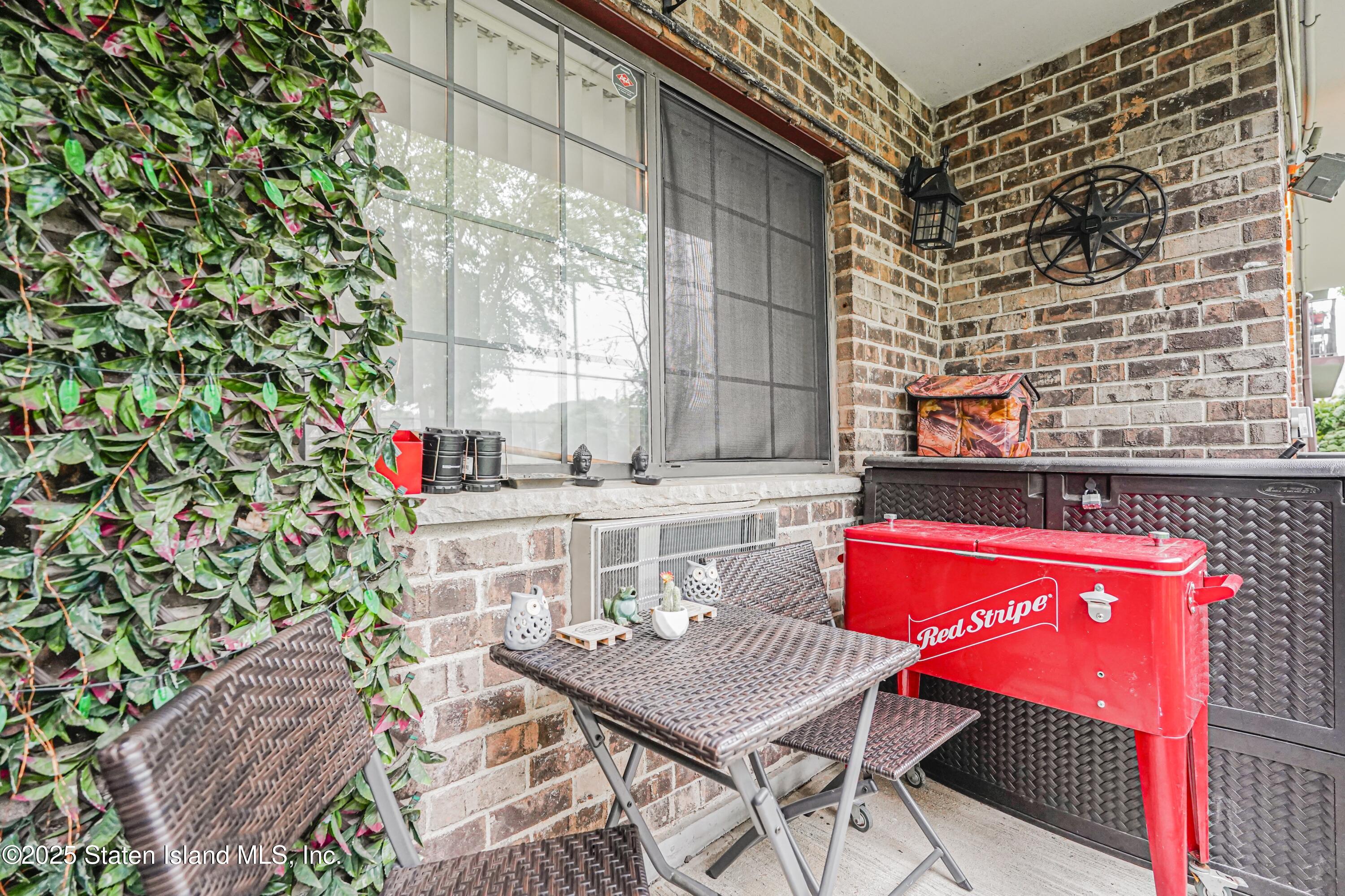 170 Devon Loop, Unit 3 Staten Island, NY 10314 - Photo 20 of 22 a balcony with table and chairs
