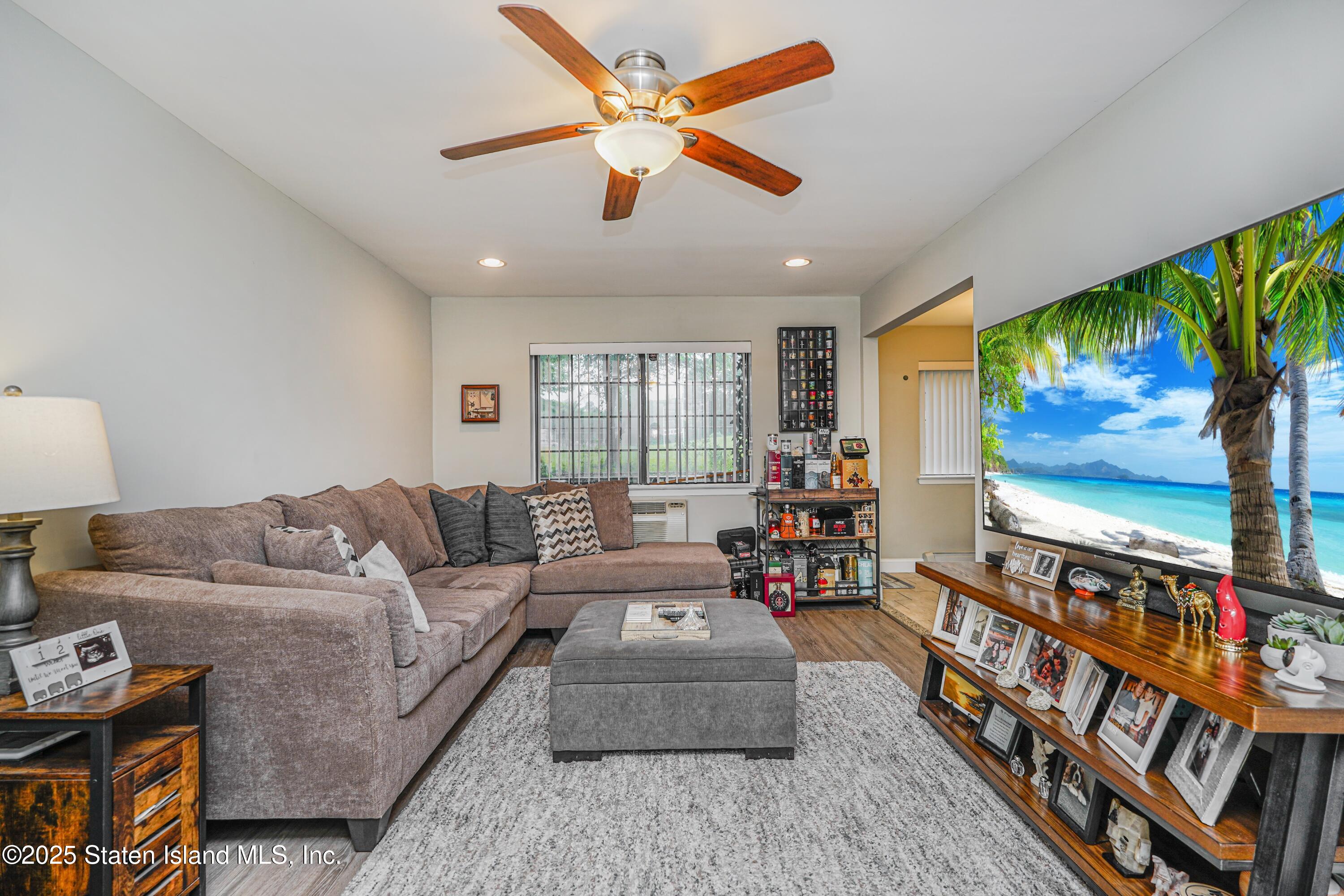 170 Devon Loop, Unit 3 Staten Island, NY 10314 - Photo 3 of 22 a living room with furniture and a flat screen tv