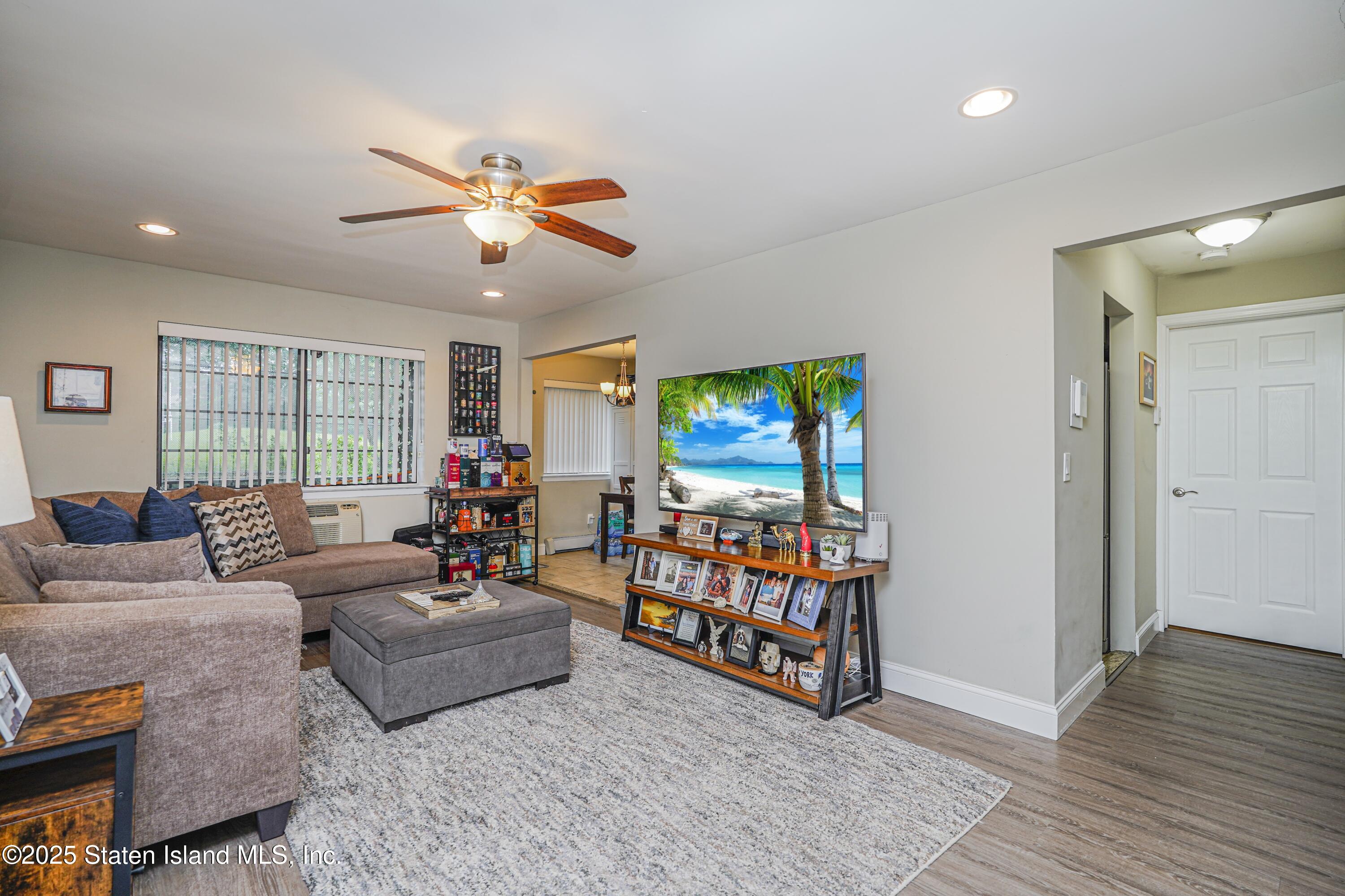 170 Devon Loop, Unit 3 Staten Island, NY 10314 - Photo 4 of 22 a living room with furniture a flat screen tv and a window