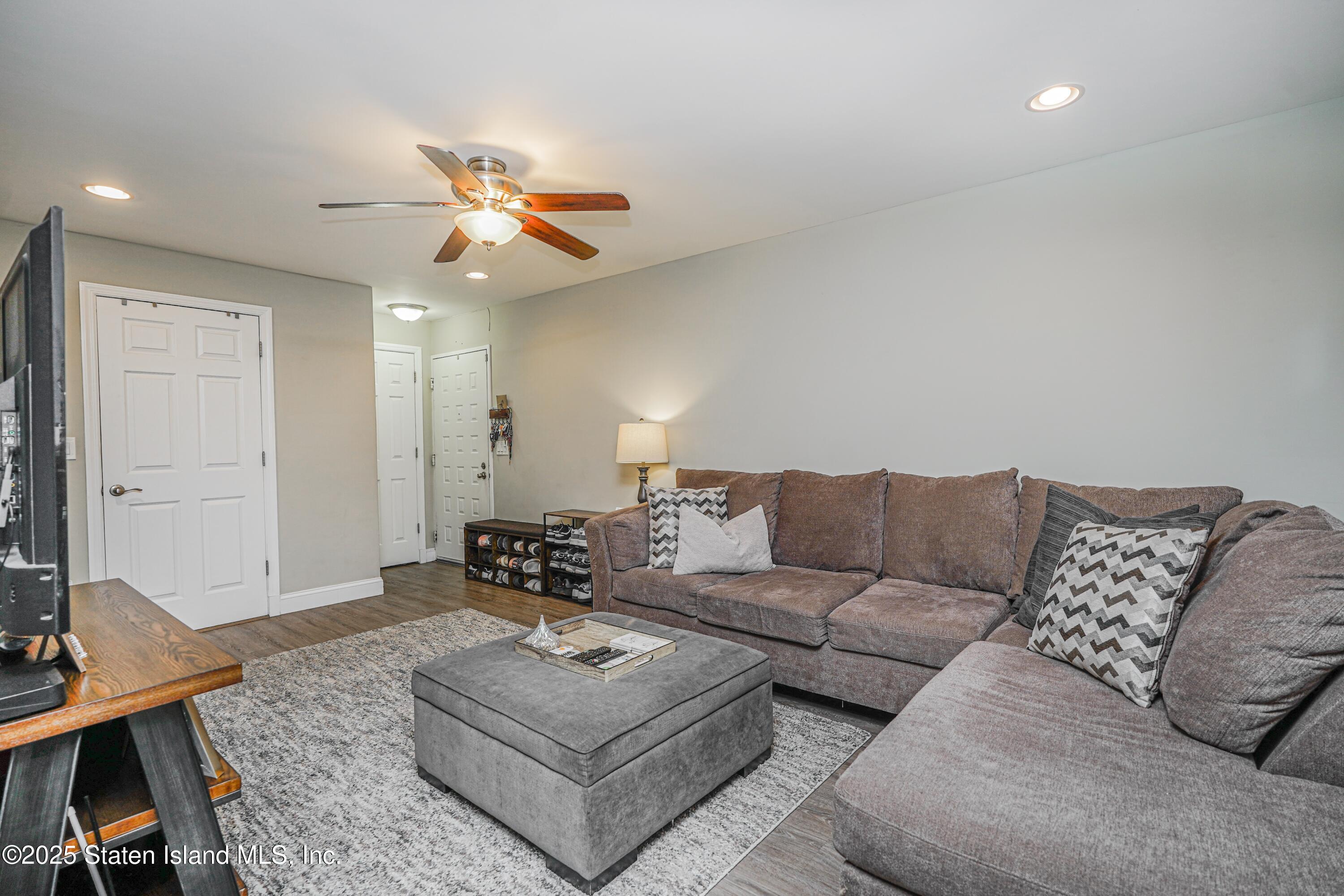170 Devon Loop, Unit 3 Staten Island, NY 10314 - Photo 5 of 22 a living room with furniture and a ceiling fan