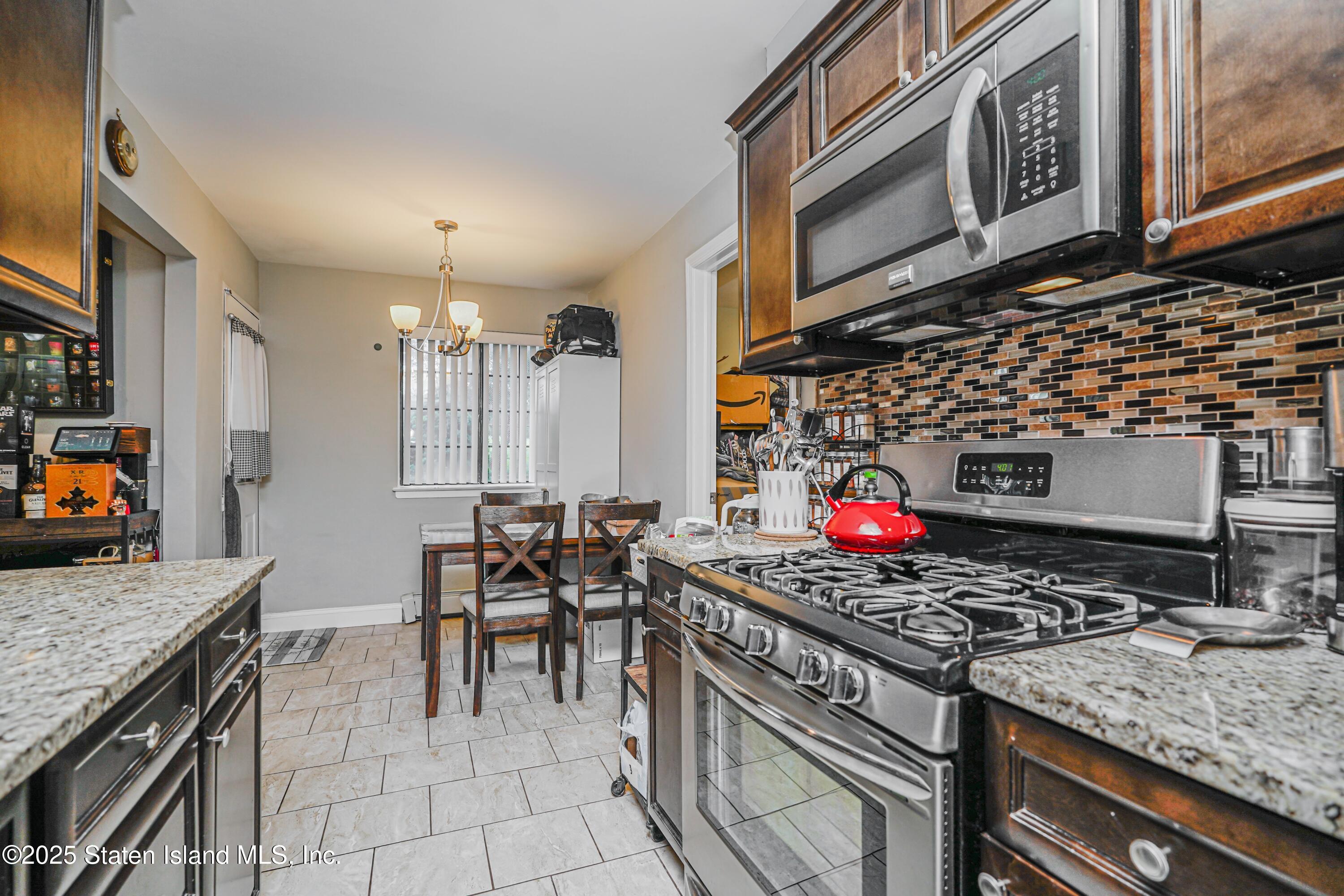 170 Devon Loop, Unit 3 Staten Island, NY 10314 - Photo 7 of 22 a kitchen with stainless steel appliances granite countertop a stove and a sink