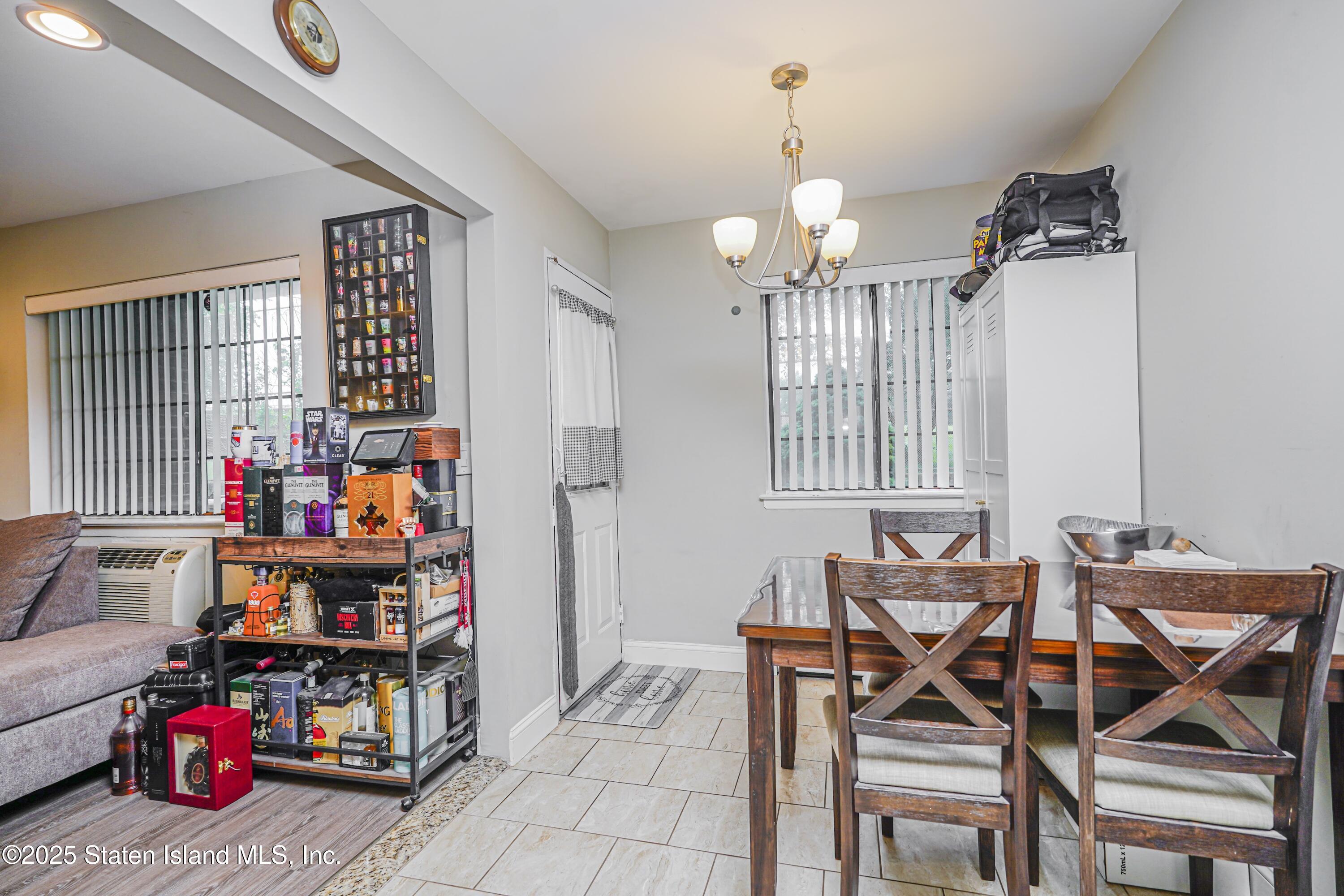 170 Devon Loop, Unit 3 Staten Island, NY 10314 - Photo 8 of 22 a view of a livingroom with furniture and a chandelier