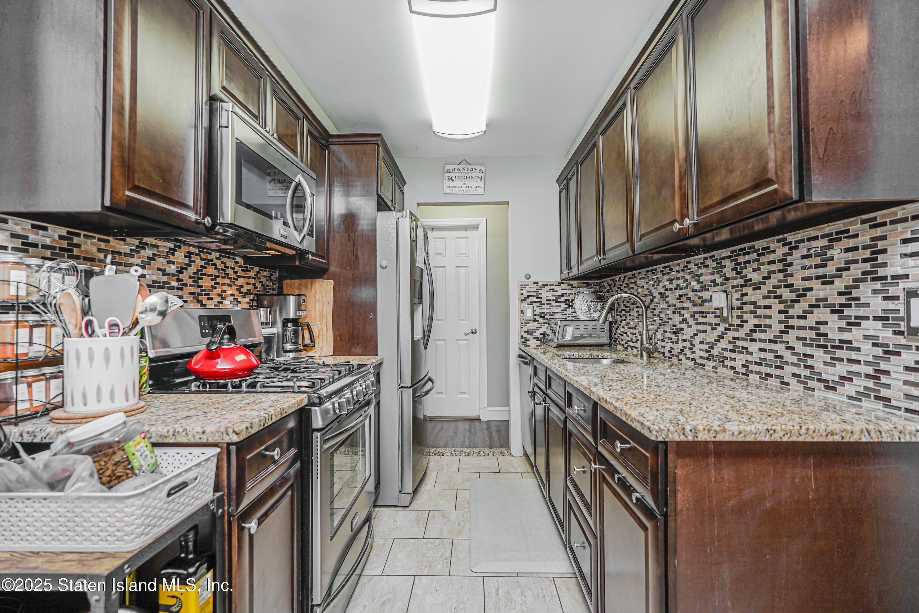 170 Devon Loop, Unit 3 Staten Island, NY 10314 - Photo 10 of 22 a utility room with stainless steel appliances granite countertop a stove and a sink