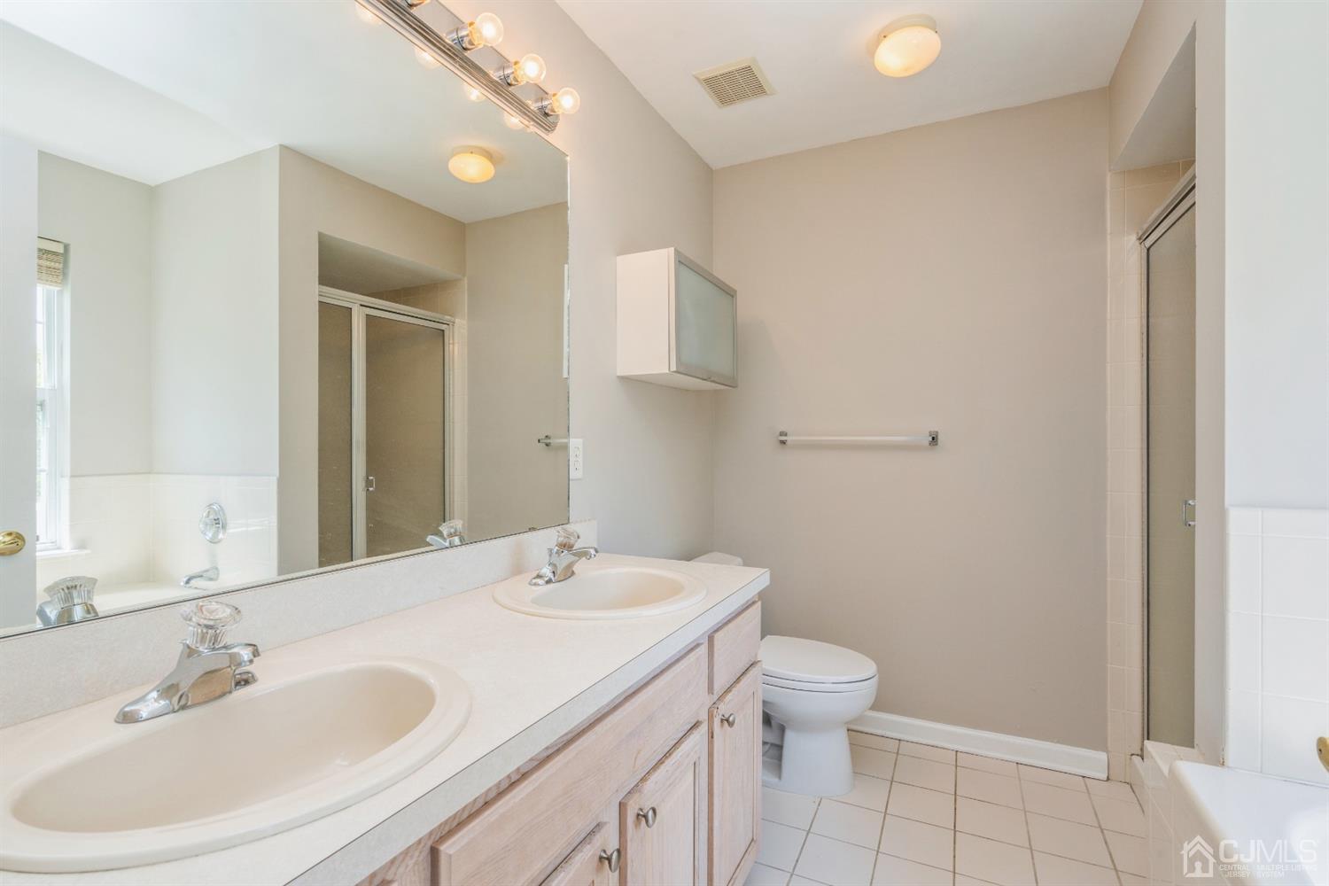 202 Hawthorne Road North Brunswick, NJ 08902 - Photo 12 of 21 a bathroom with a sink a toilet and shower