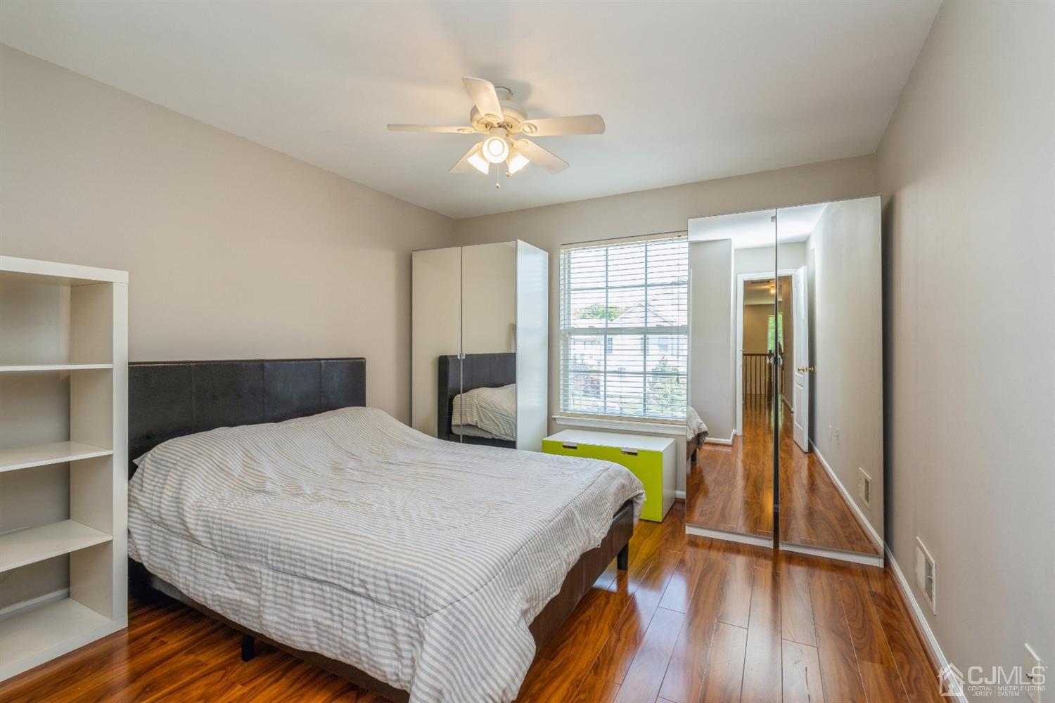 202 Hawthorne Road North Brunswick, NJ 08902 - Photo 14 of 21 a spacious bedroom with a bed and a chandelier