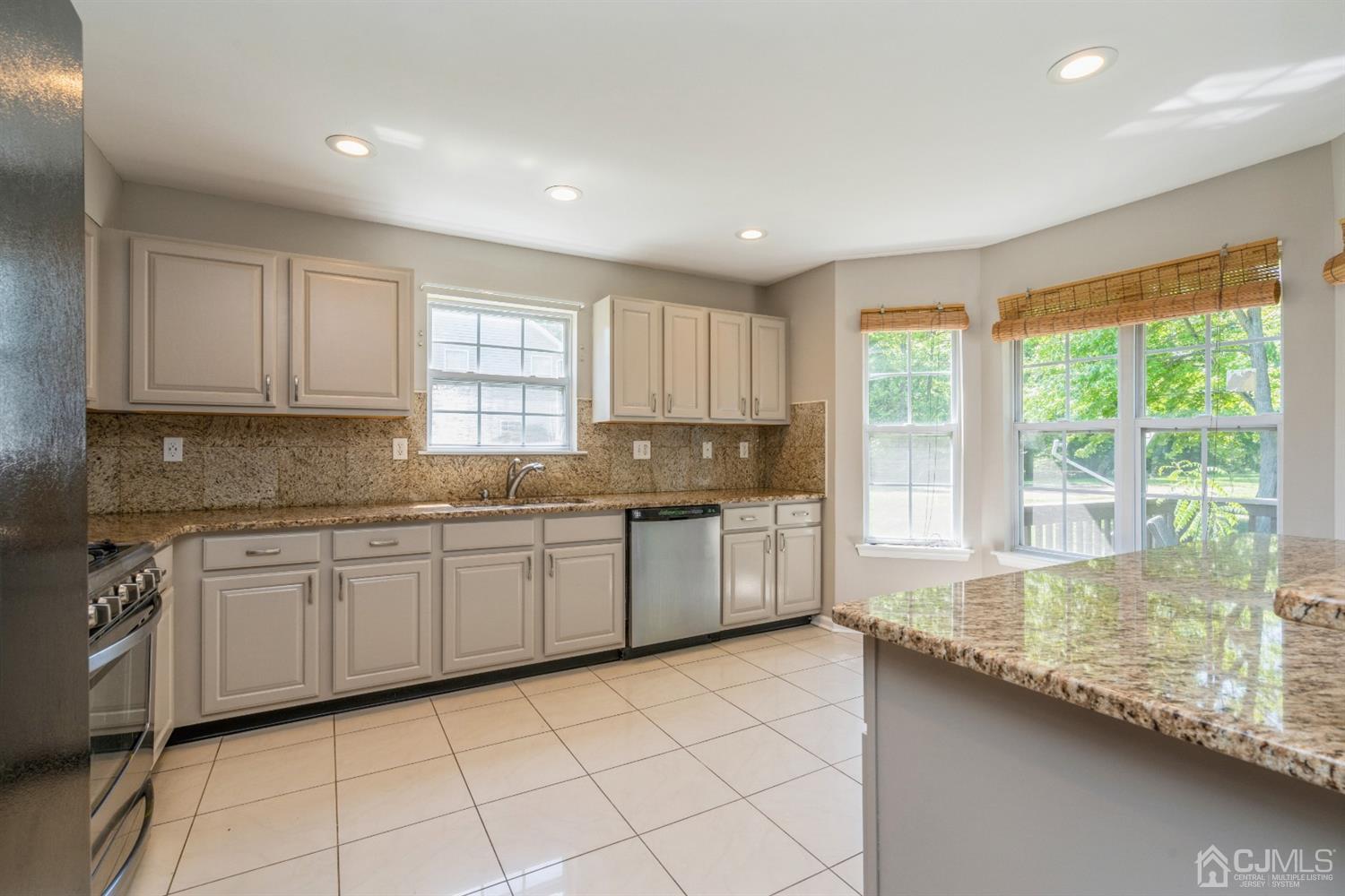 202 Hawthorne Road North Brunswick, NJ 08902 - Photo 8 of 21 a kitchen with granite countertop sink and cabinets