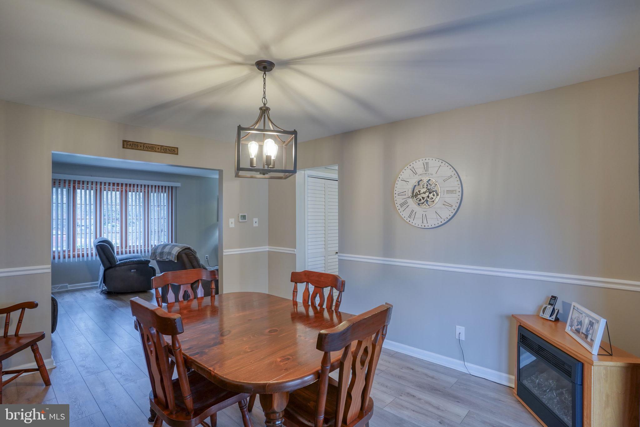 3850 Naamans Creek Road Upper Chichester, PA 19061 - Photo 12 of 53 a view of a dining room with furniture a chandelier and wooden floor