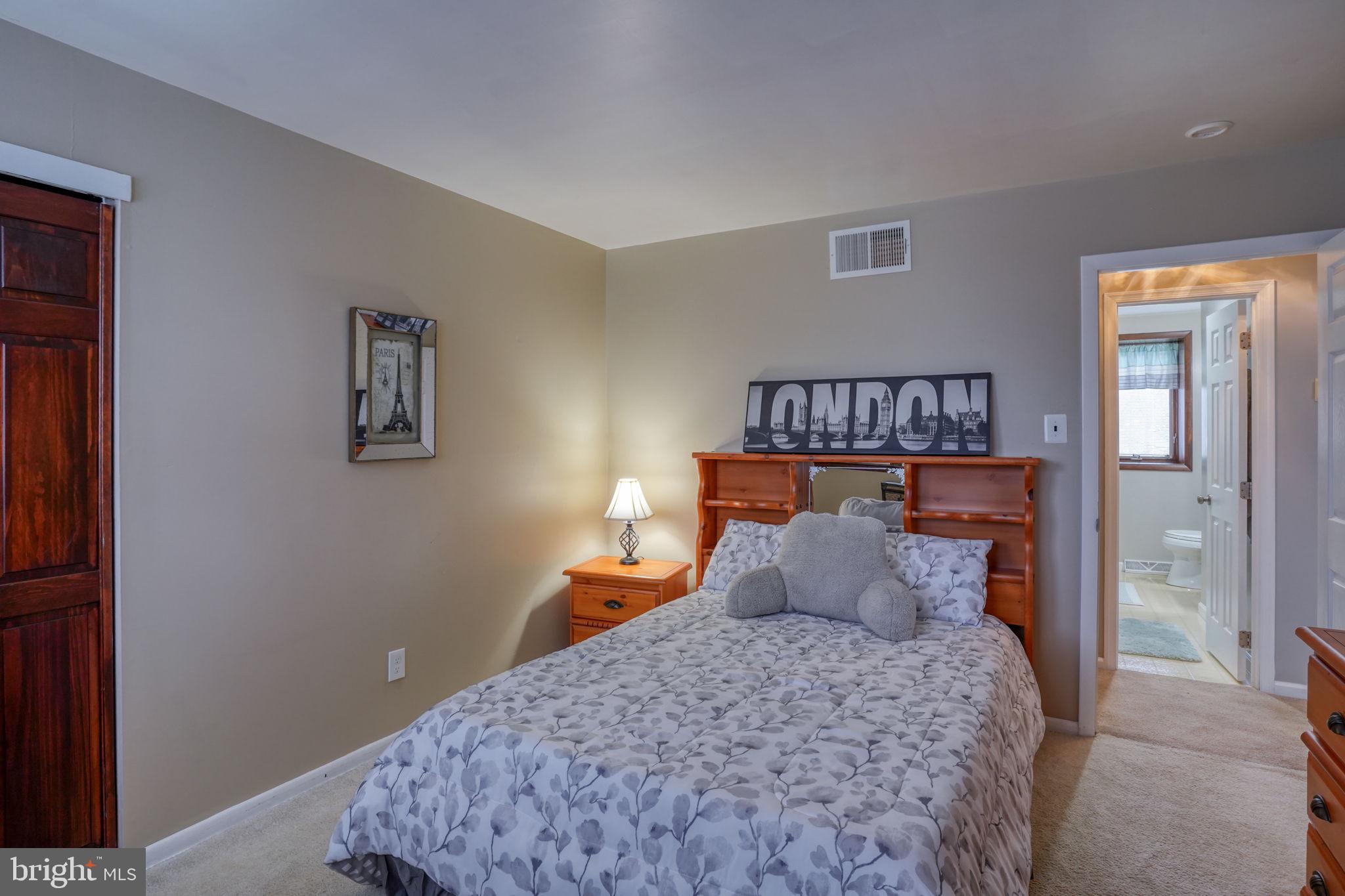 3850 Naamans Creek Road Upper Chichester, PA 19061 - Photo 29 of 53 a bedroom with a bed and painting on the wall