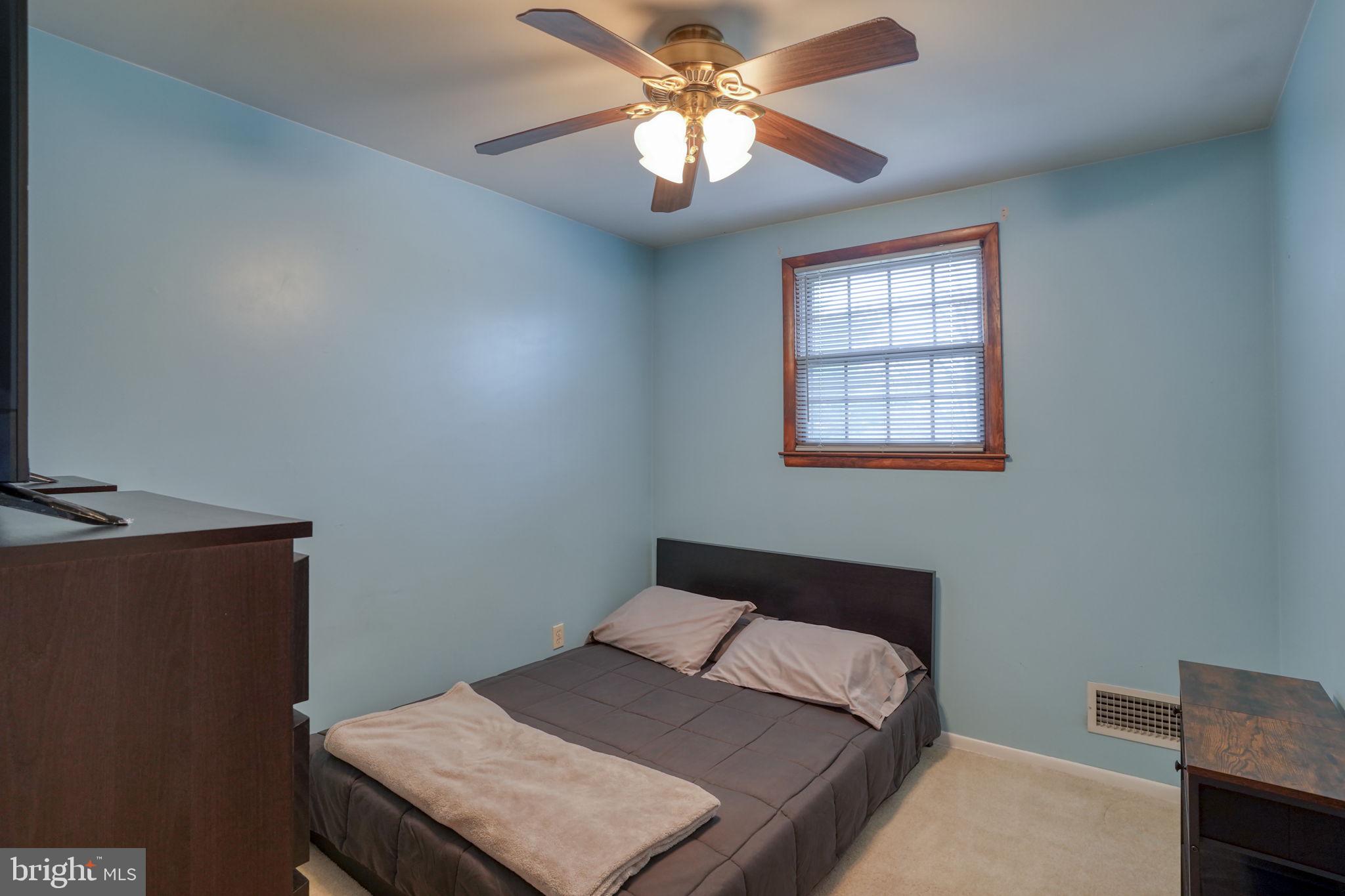 3850 Naamans Creek Road Upper Chichester, PA 19061 - Photo 30 of 53 a bedroom with a bed and a chandelier