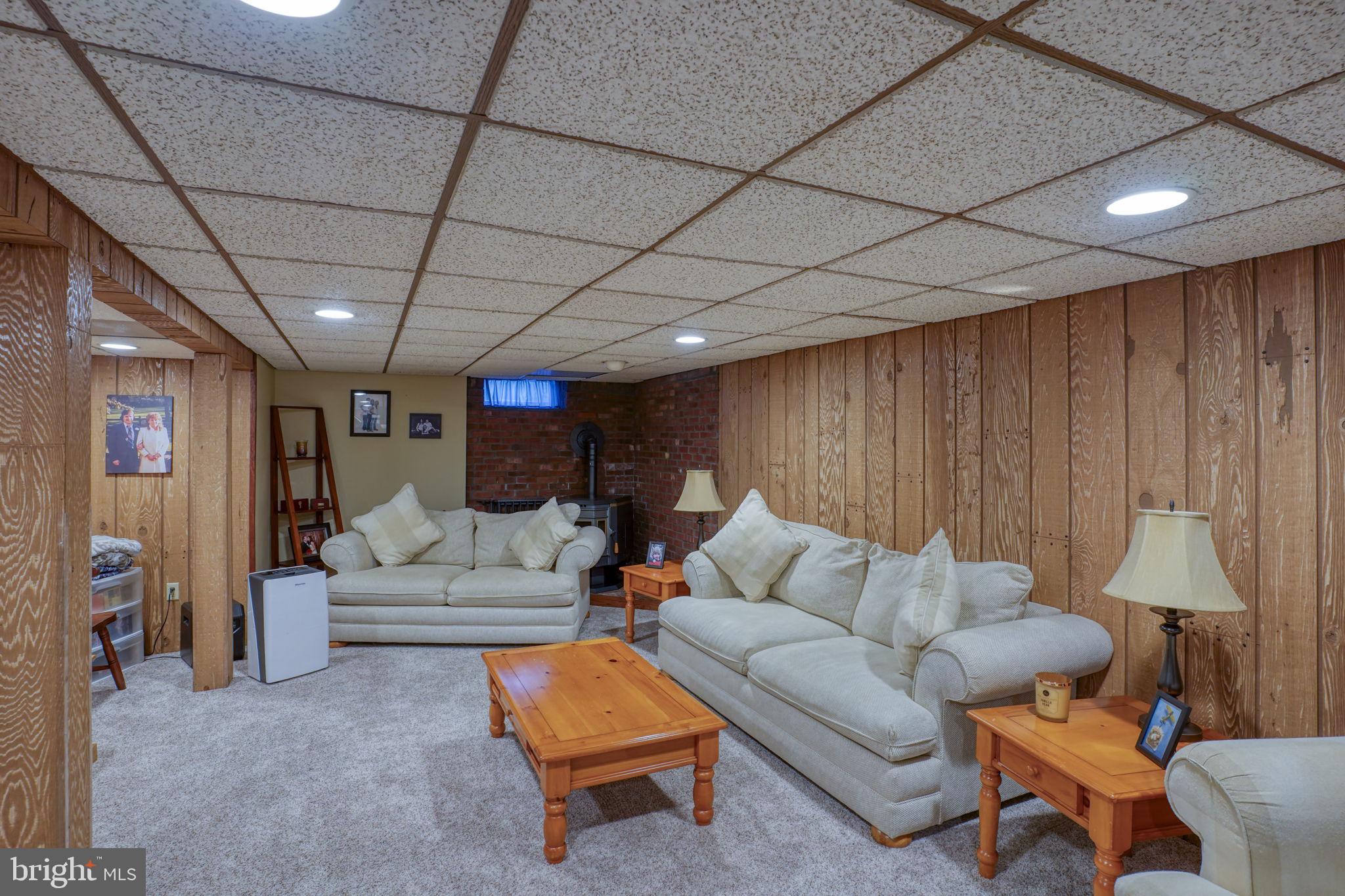 3850 Naamans Creek Road Upper Chichester, PA 19061 - Photo 37 of 53 a living room with furniture a lamp and a projector