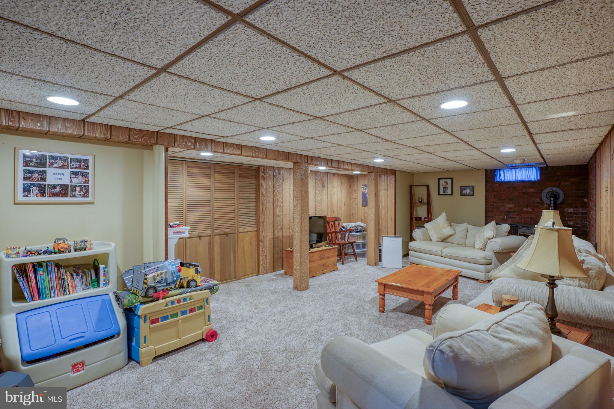 3850 Naamans Creek Road Upper Chichester, PA 19061 - Photo 38 of 53 a living room with furniture and a flat screen tv