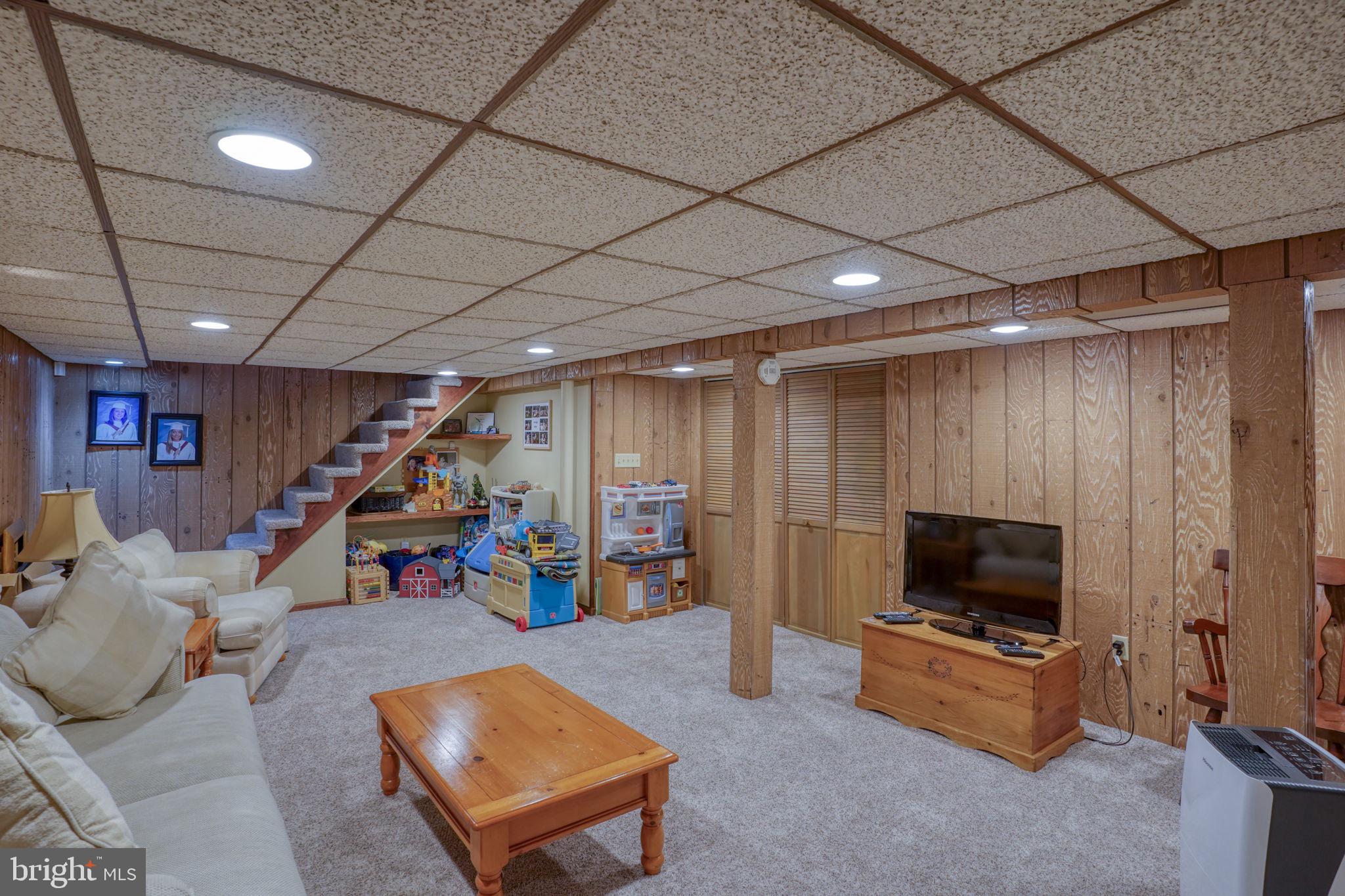 3850 Naamans Creek Road Upper Chichester, PA 19061 - Photo 39 of 53 a living room with furniture and a flat screen tv